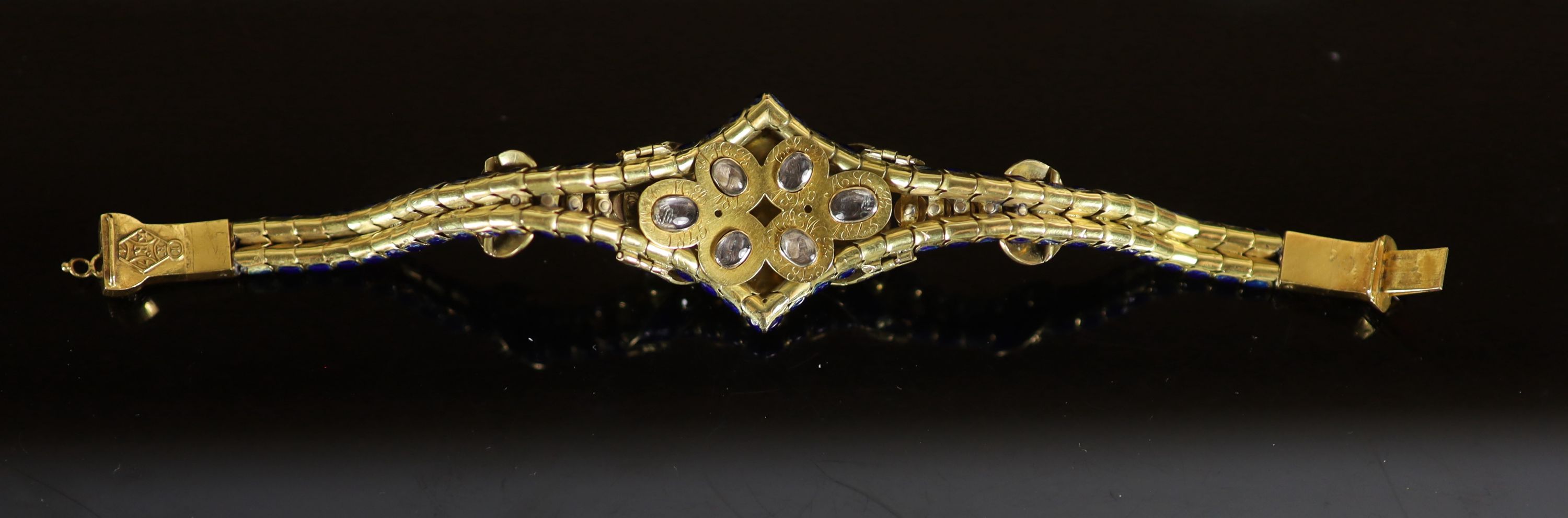 A good Victorian gold, blue enamel, old cut diamond, foil backed garnet and graduated split pearl set articulated memorial bracelet